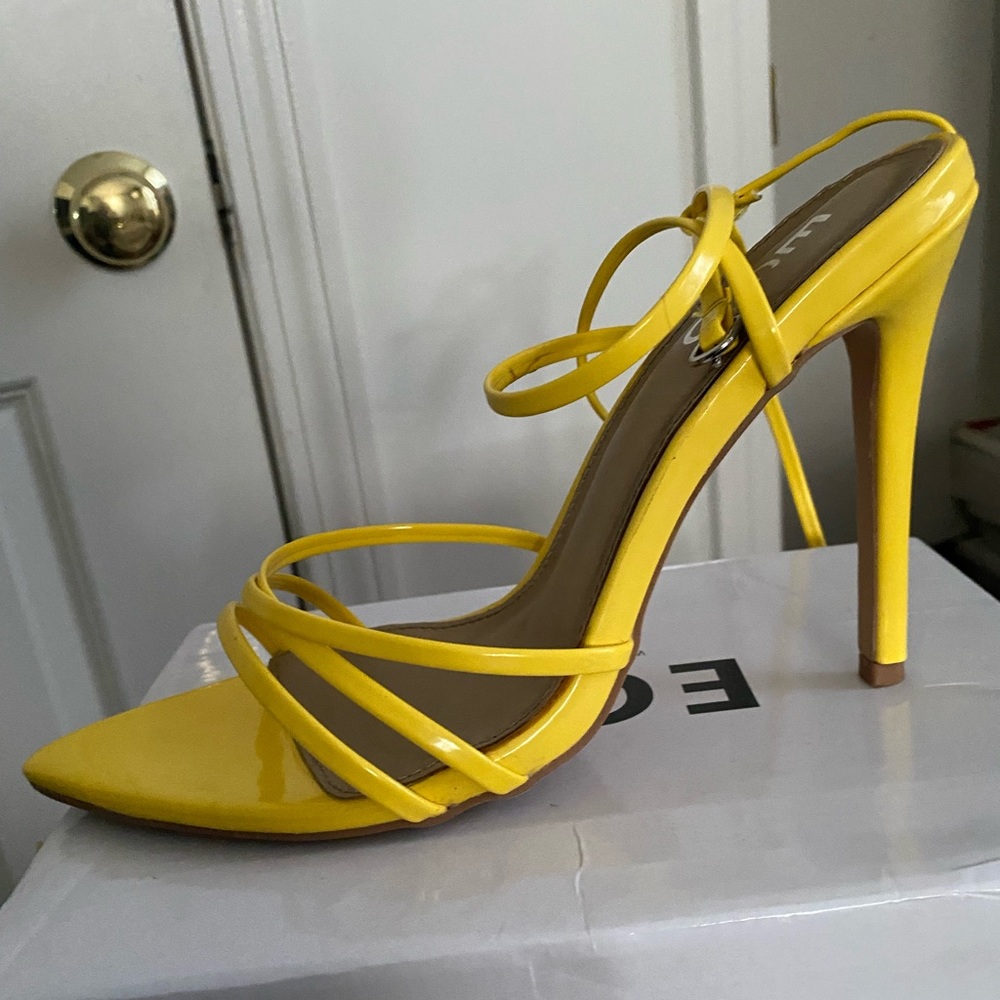 Open toe high heels with buckle.
